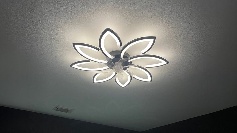 A flower-shaped LED ceiling fixture installed on a flat ceiling