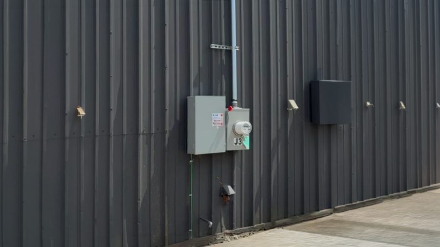 Meter and disconnect installed on the metal siding of a commercial building